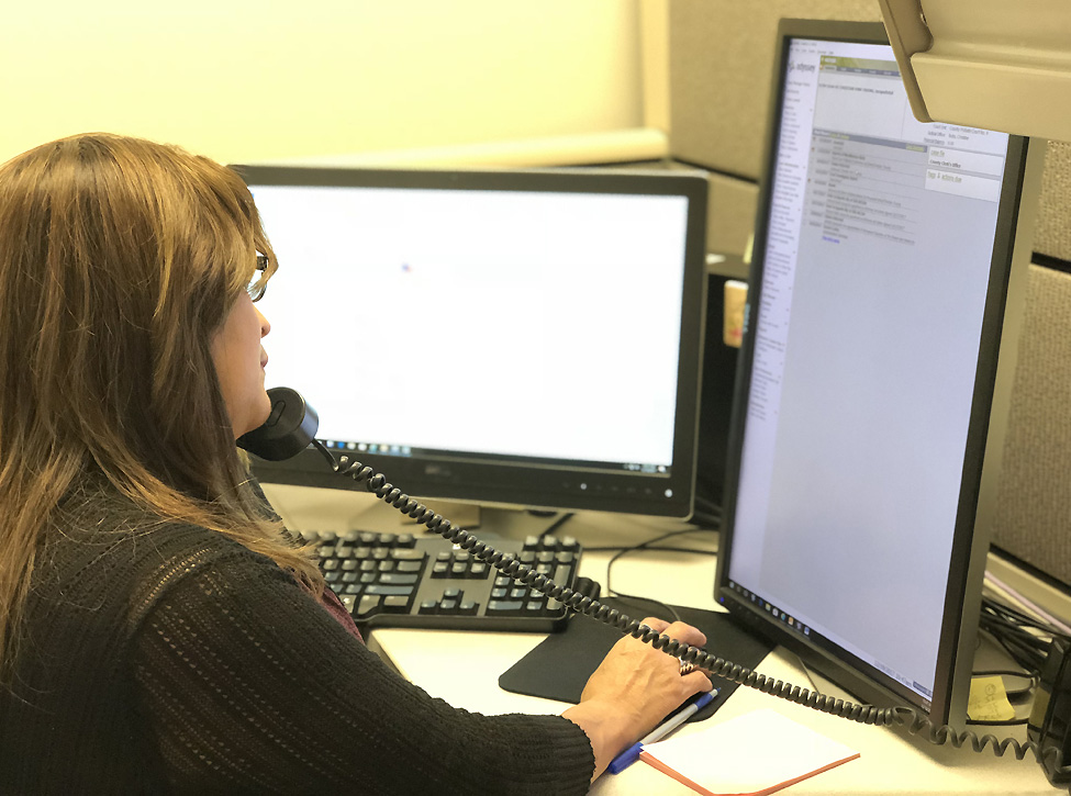 Photo of a clerk answering the phone